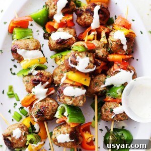 Turkey meatballs and bell pepper slices on skewers, and drizzled with homemade garlic yogurt sauce.