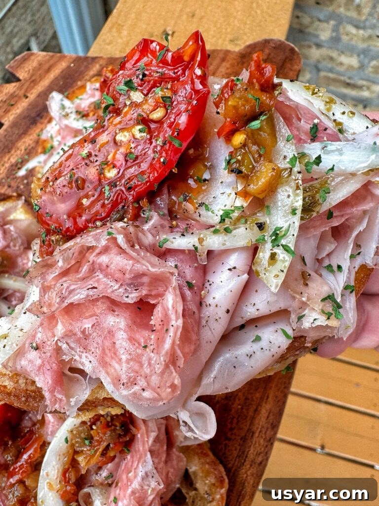 Open-Faced Italian Subs Recipe with Melty Mozzarella 9 A close up of an open faced sub sandwich.