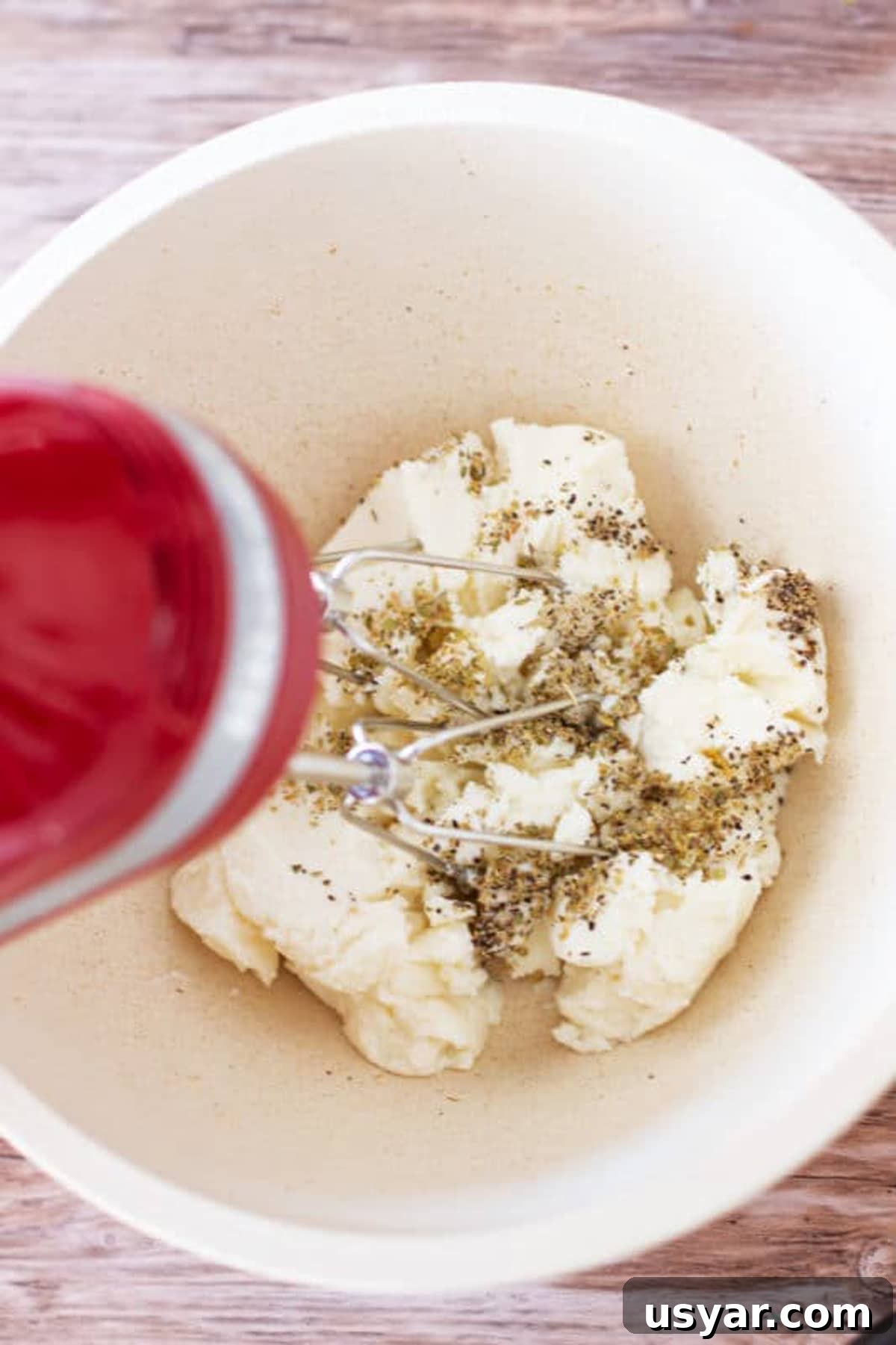 Baked Chicken Caprese with Mozzarella and Tomatoes 4 Bowl containing ricotta cheese mixed with dried oregano.