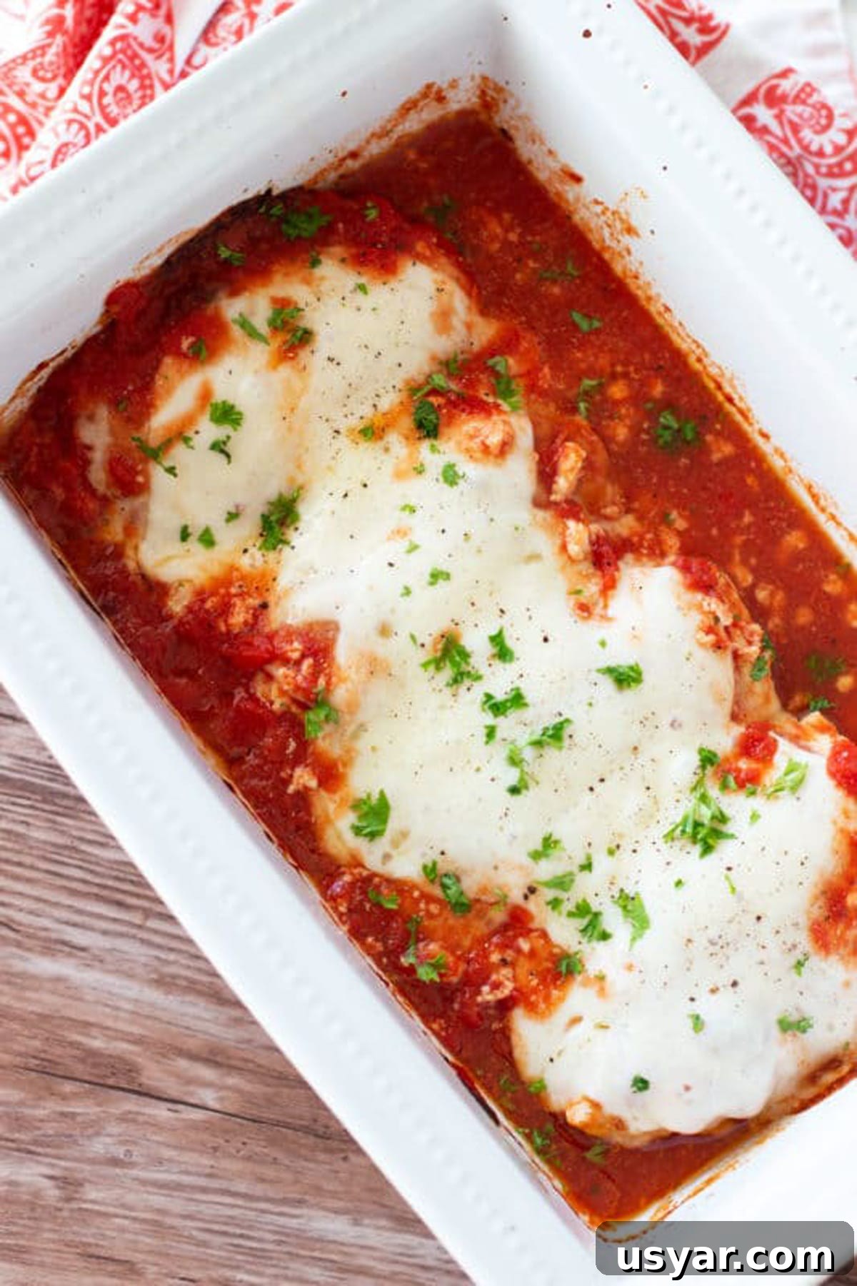 Baked Chicken Caprese with Mozzarella and Tomatoes 10 Baking dish with 4 chicken breasts covered in ricotta cheese, crushed tomatoes and melted Provolone cheese topped with basil.