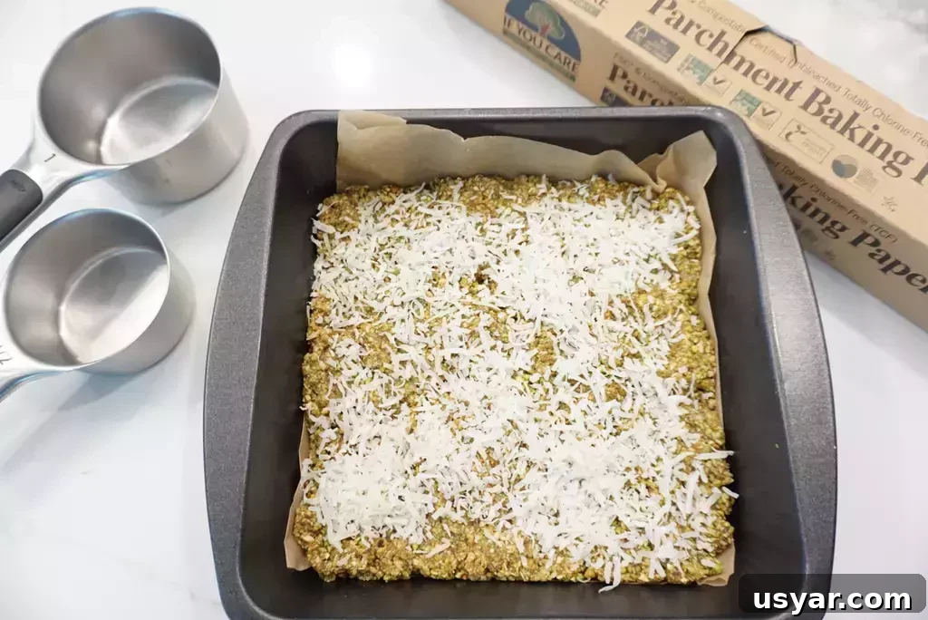 Homemade Pistachio Snack Squares Recipe 6 pistachio snack squares in pan with coconut flakes