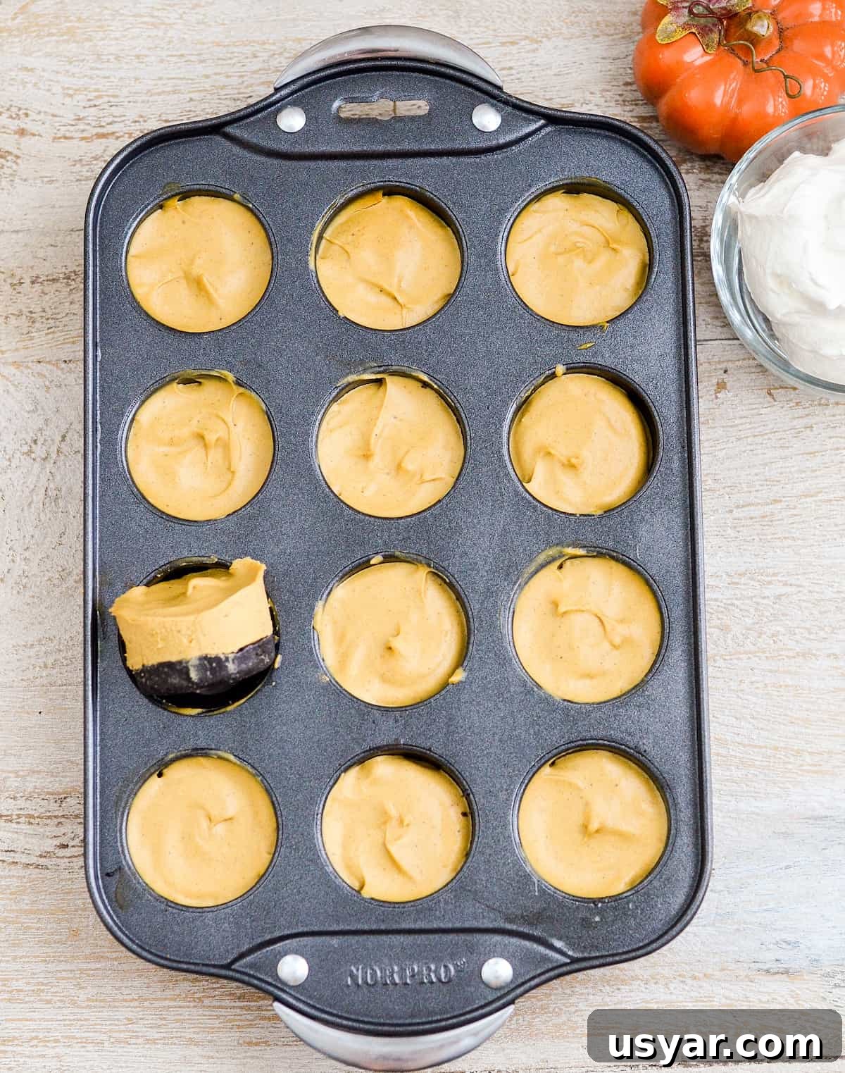No-Bake Mini Vegan Pumpkin Pies are the perfect elegant fall dessert! They are gluten-free, dairy-free, refined sugar free, paleo, vegan and SUPER easy to make! #vegan #pumpkinpie #nobake #dessert #paleo #glutenfree #dairyfree Overhead view of No-Bake Vegan Pumpkin Pies in a mini cheesecake pan.