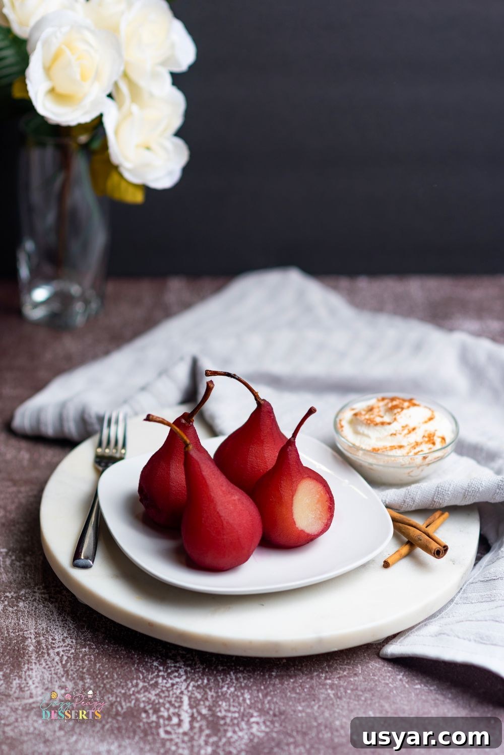 Red Wine Poached Pears Recipe with Vanilla and Cinnamon 5 Poached pears in red wine on a white serving plate