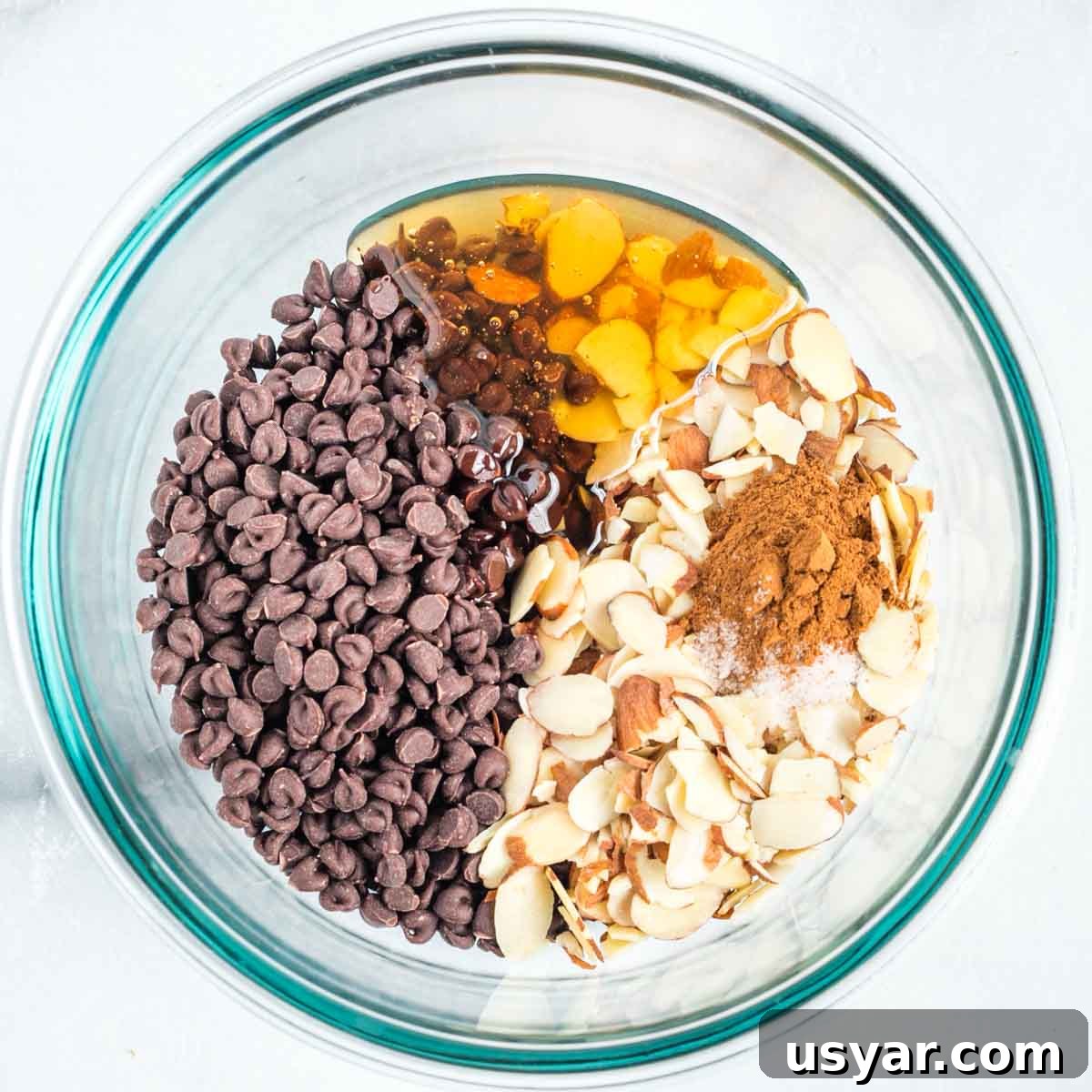 Oven Baked Pears with Almonds and Dark Chocolate 4 Chocolate chips, sliced almonds, cinnamon, honey, salt and vanilla in a medium sized glass bowl.