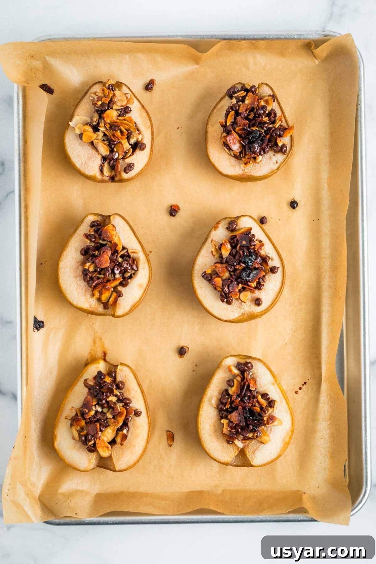 Oven Baked Pears with Almonds and Dark Chocolate 10 Baked pear halves with melty chocolate, browned almonds stuffed into the cavity.