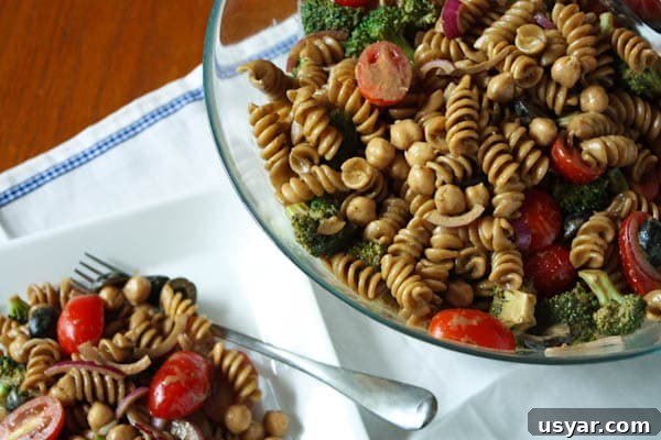 Pasta Salad with Balsamic Basil Vinaigrette pasta salad on a plate with fork