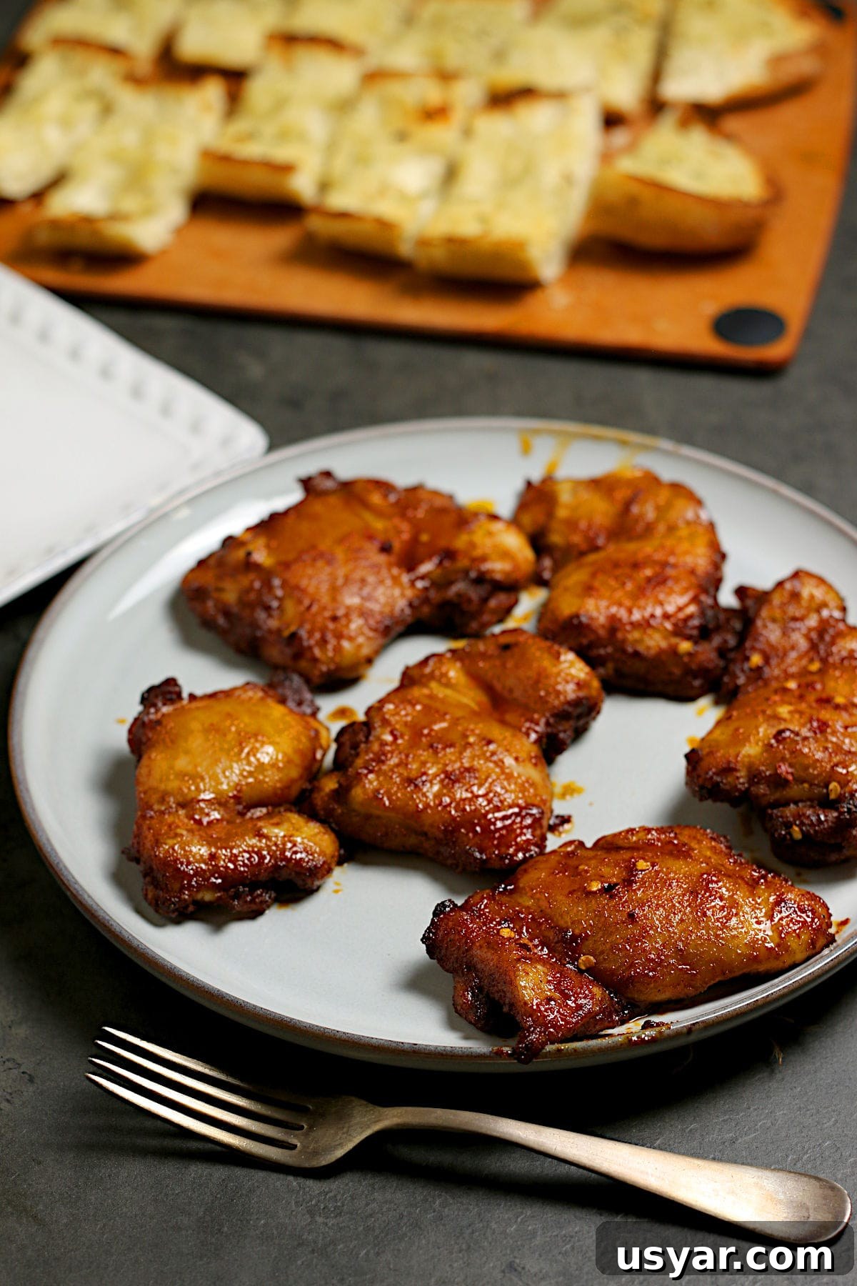 Hot Honey-Glazed Chicken Thighs Recipe 2 A platter of Hot Honey Glazed Chicken Thighs.