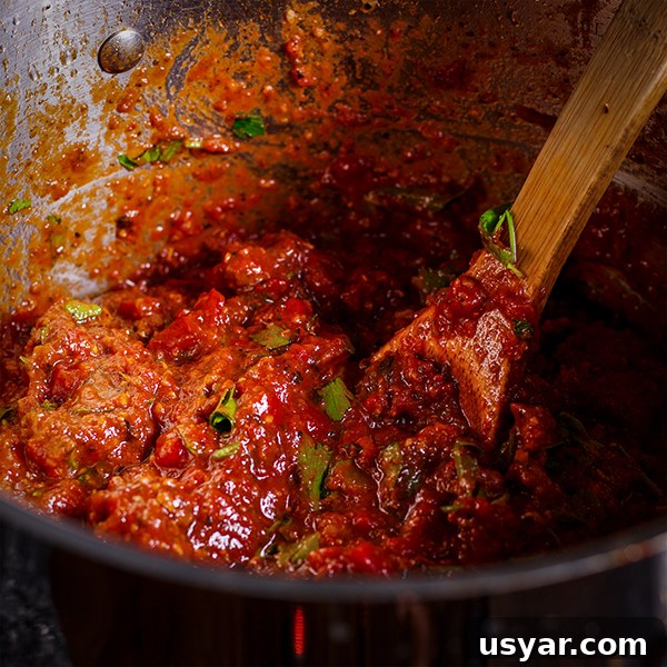 Cheesy Sausage Lasagna Recipe with Homemade Marinara 3 A pot of homemade marinara sauce ready to be added to homemade lasagana.