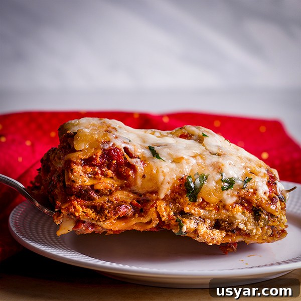 Cheesy Sausage Lasagna Recipe with Homemade Marinara 7 Serving a slice of the best homemade lasagna with sausage and cheese.