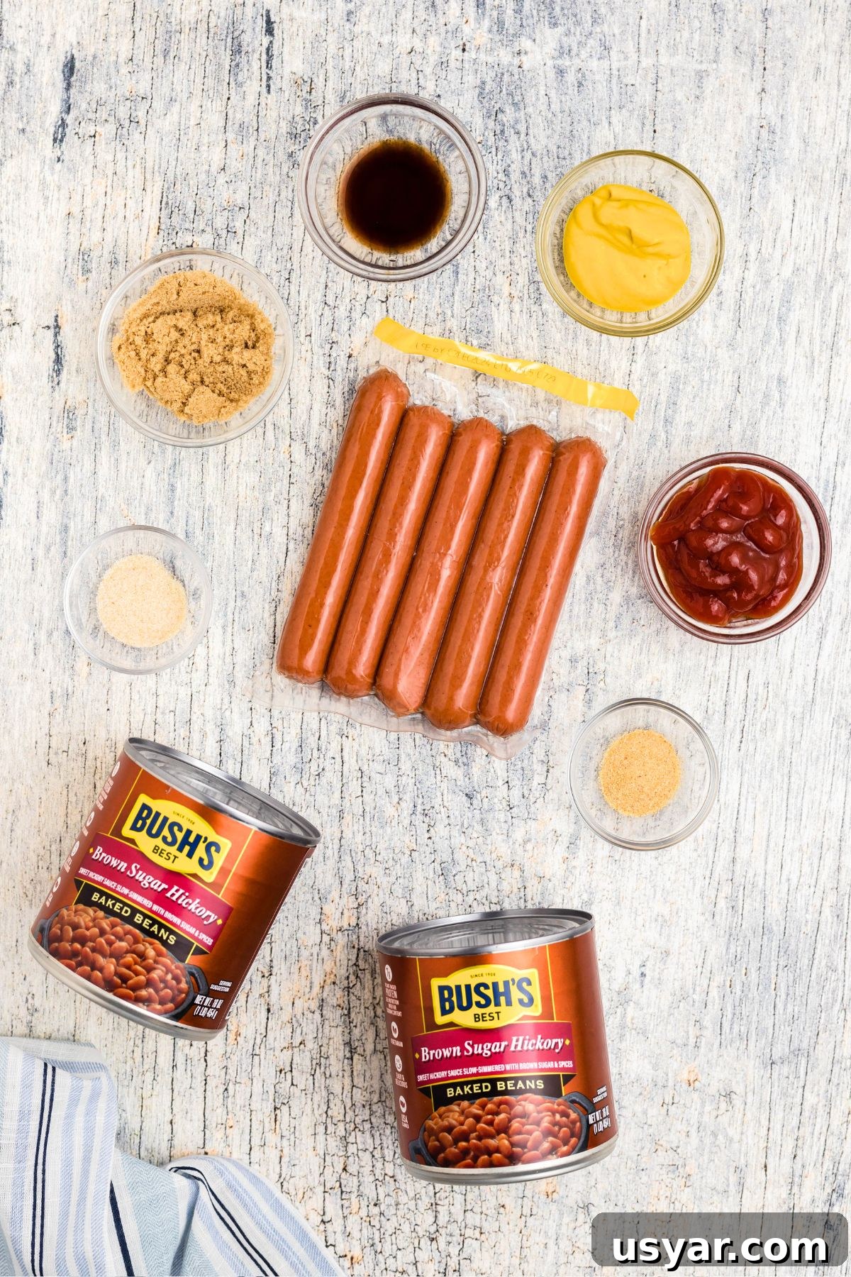 Beanie Weenies Recipe: Classic Hot Dogs in Baked Beans 3 Ingredients needed to make beanie weenies, measured in small glass bowls.