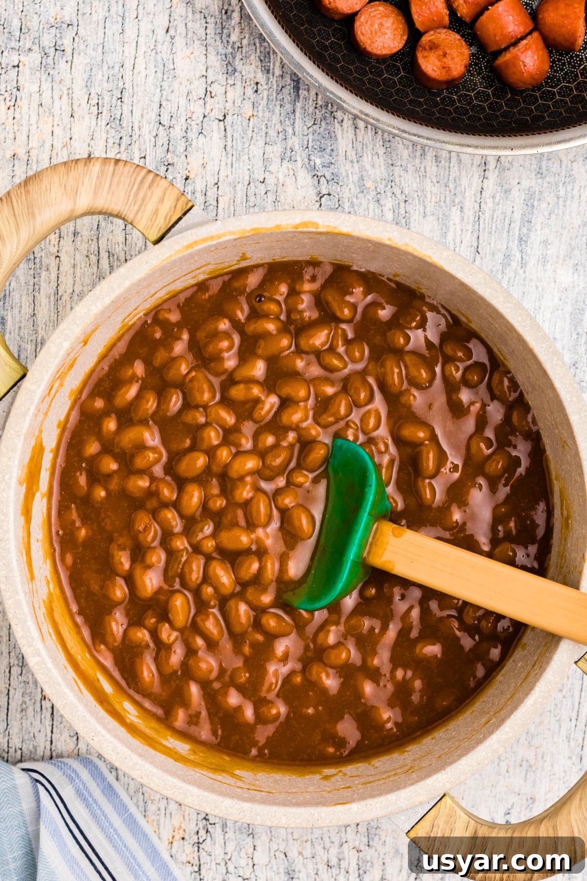 Beanie Weenies Recipe: Classic Hot Dogs in Baked Beans 6 Beans and other ingredients in saucepan after simmering.