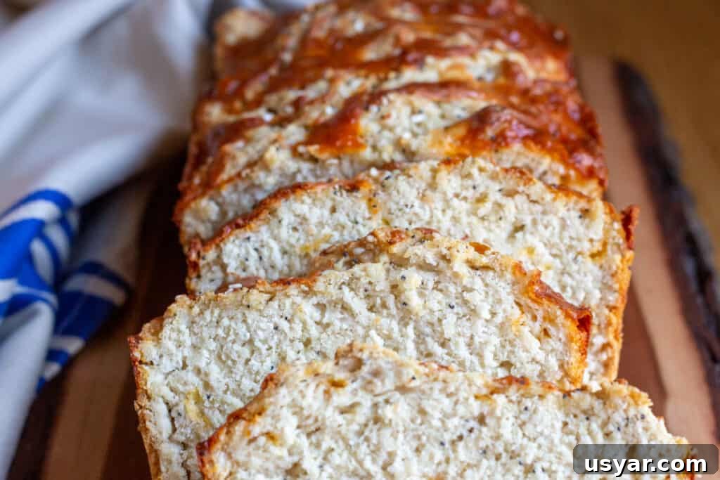 Crusty Herbed Beer Bread Recipe with Garlic and Thyme 6 Fresh from the oven beer bread with slices and a tea towel.