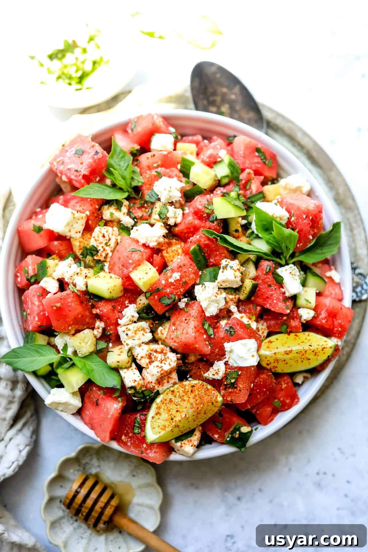 Refreshing Watermelon Basil Salad Recipe 2 White bowl with ingredients mixed together to make watermelon salad with feta.