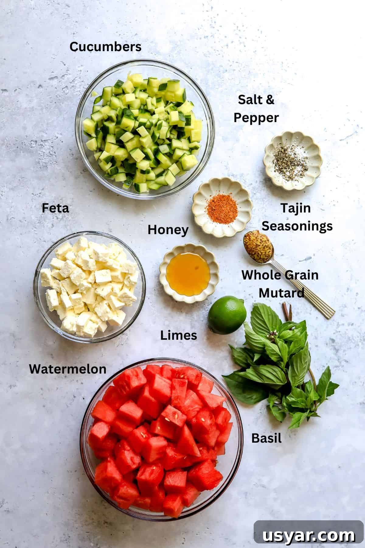 Refreshing Watermelon Basil Salad Recipe 3 Ingredients for the recipe on a grey countertop.