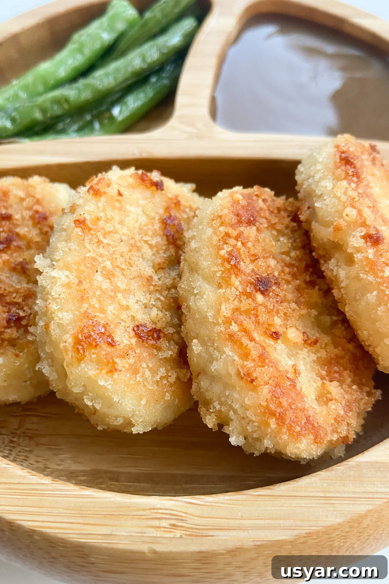 Turn Leftover Turkey into Crispy Nuggets 2 Leftover turkey nuggets served with a side of gravy and green beans