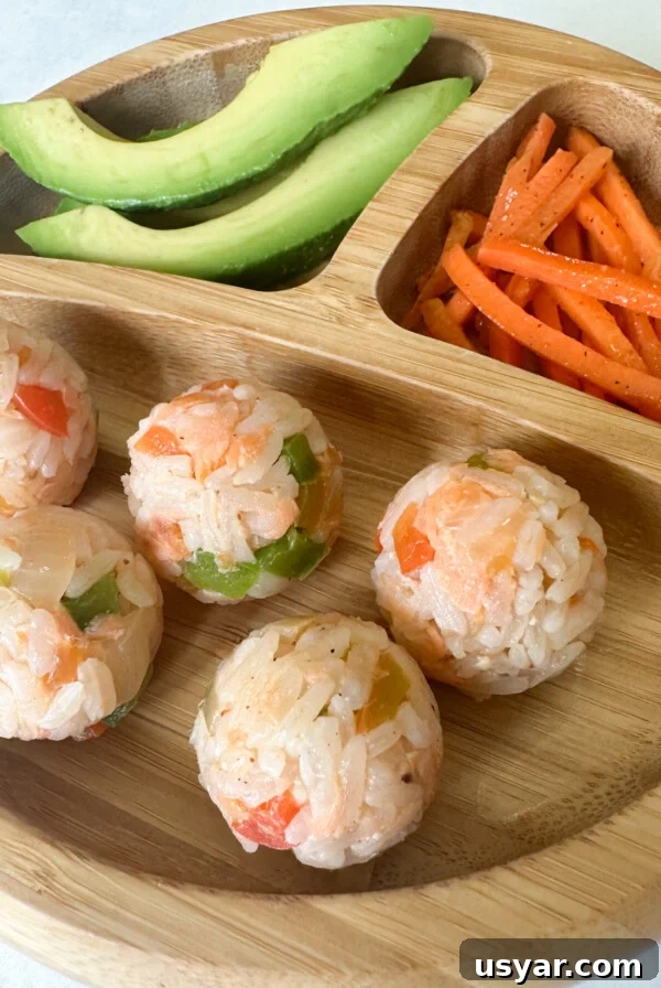 Salmon rice balls served with avocado and carrots.