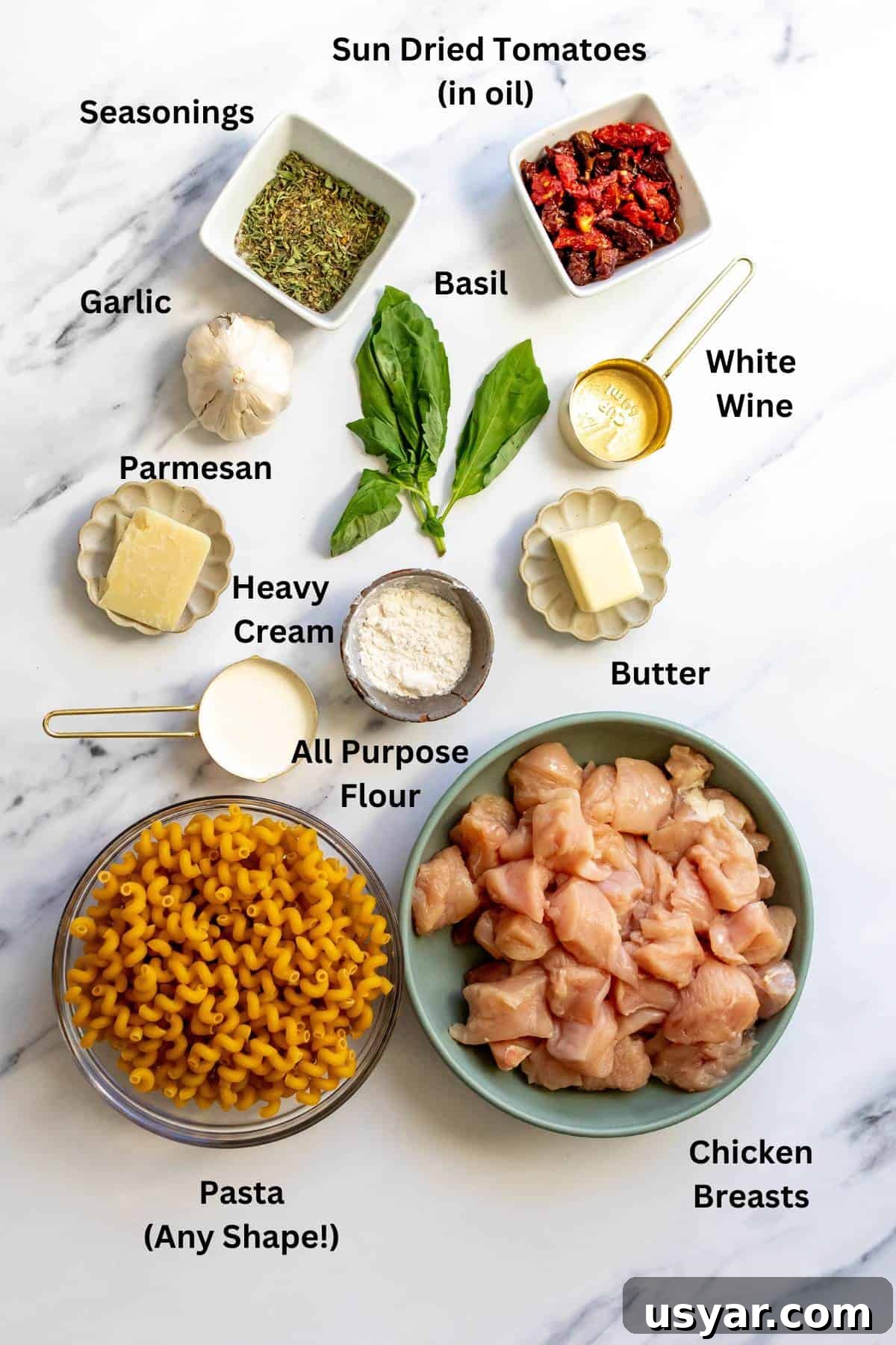 Ingredients needed to make the recipe on a white marble counter in bowls and on plates.