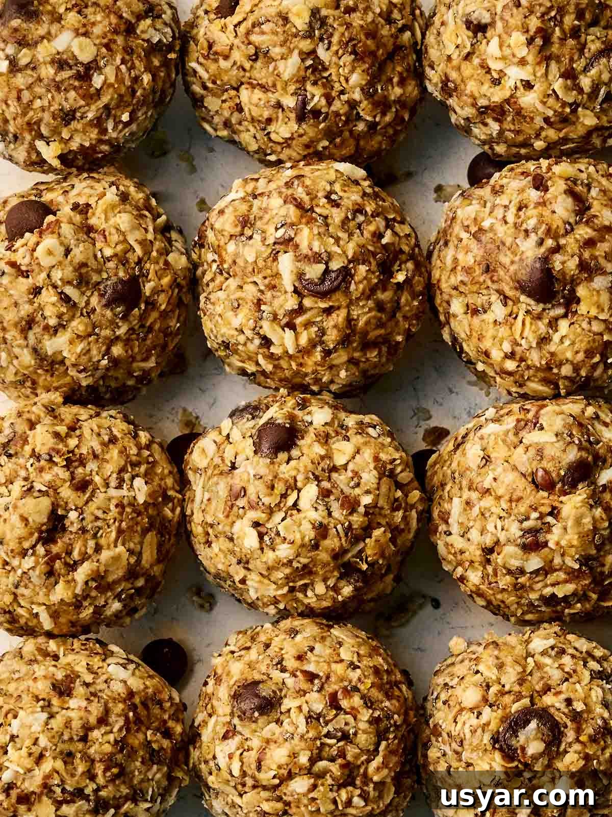 No-Bake Peanut Butter Oat Energy Balls Recipe 3 Three rows of rolled up healthy, vegan Energy Bites.
