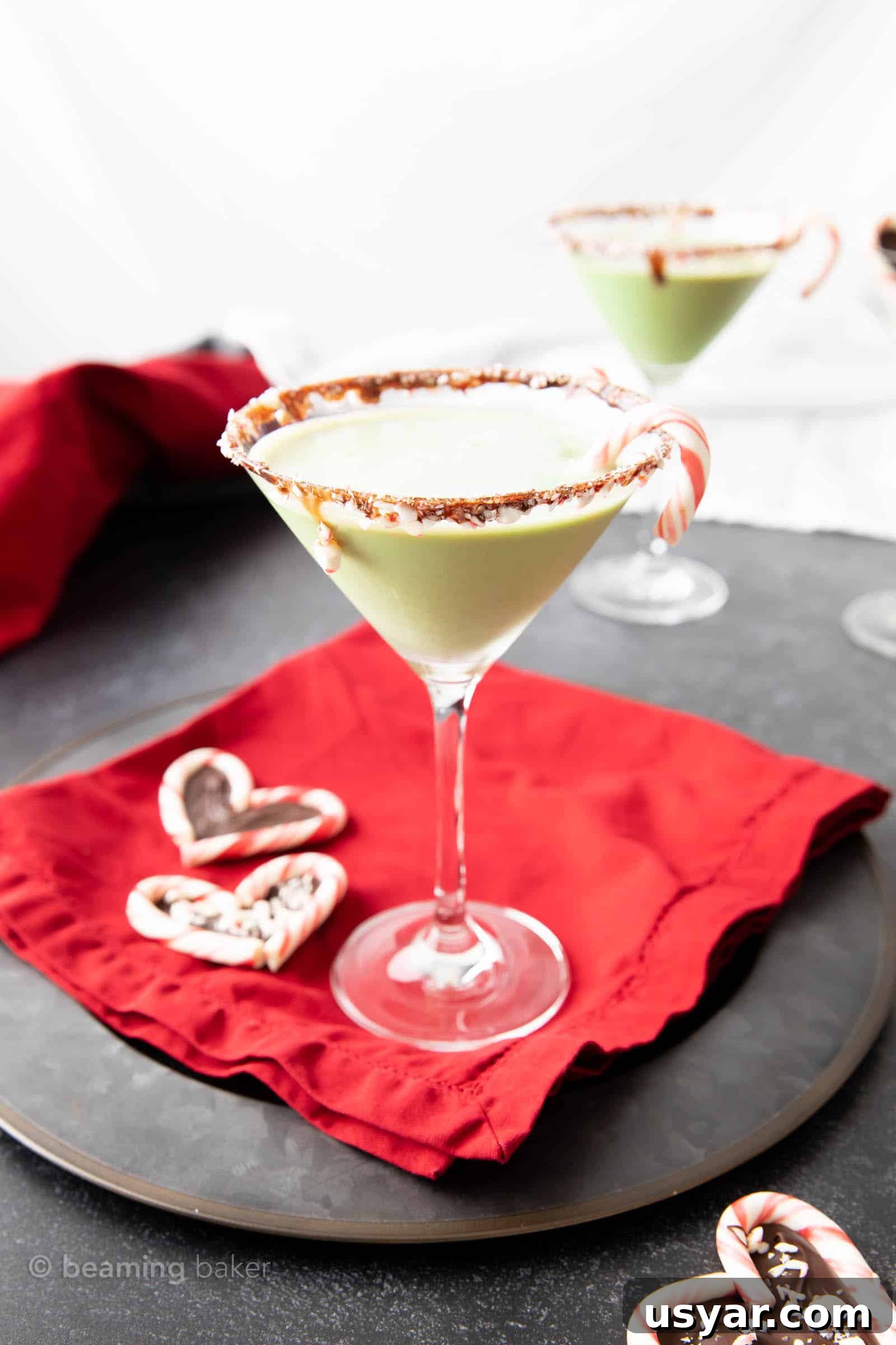 Chocolate Peppermint Martini Recipe 3 Chocolate mint martini on a red cloth with candy cane hearts and another martini in the background