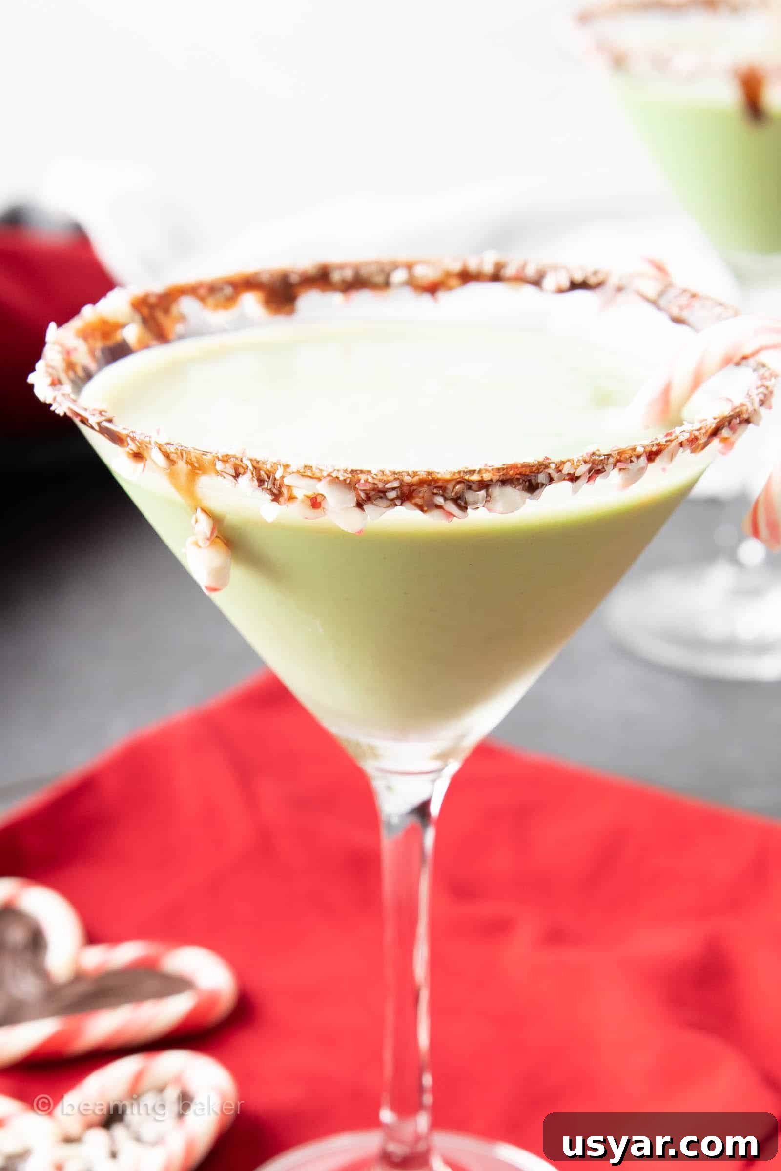 Chocolate Peppermint Martini Recipe 4 super closeup shot of martini glasses filled with a chocolate peppermint martini and garnished with a mini candy cane