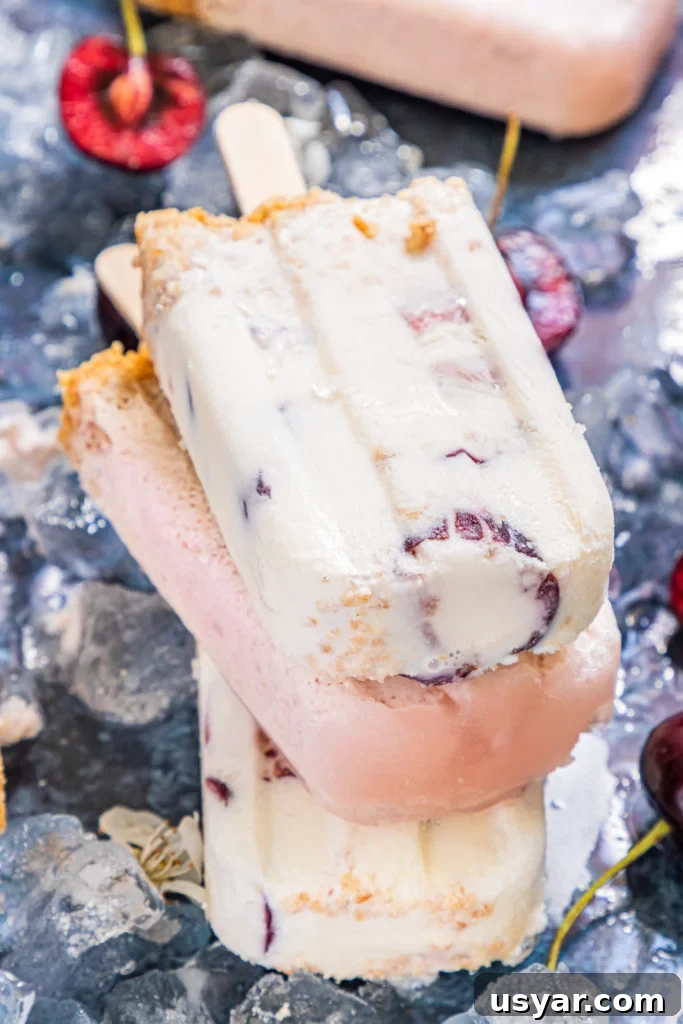 a stack of three cherry cheesecake popsicles