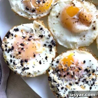 Classic Southern Sausage Gravy Recipe 16 Eggs baked in a muffin tin on plate topped with everything bagel seasoning.
