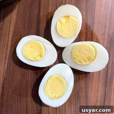 Classic Southern Sausage Gravy Recipe 17 Two hard boiled eggs sliced in half arranged like a flower.
