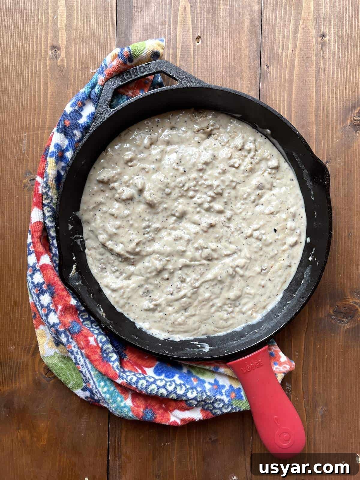 Classic Southern Sausage Gravy Recipe 8 A cast iron skillet filled with sausage gravy.