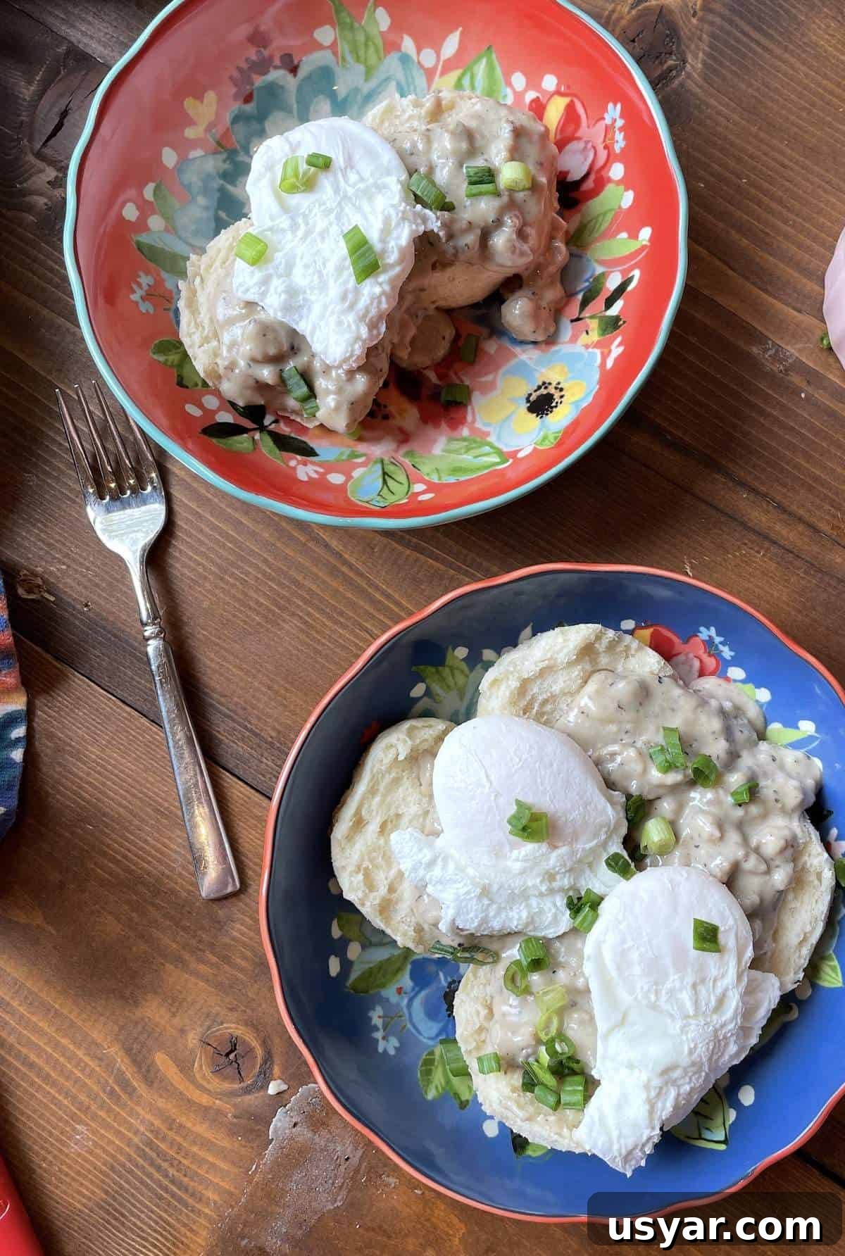 Classic Southern Sausage Gravy Recipe 10 Two bowls with two biscuits topped with sausage gravy and two poached eggs.