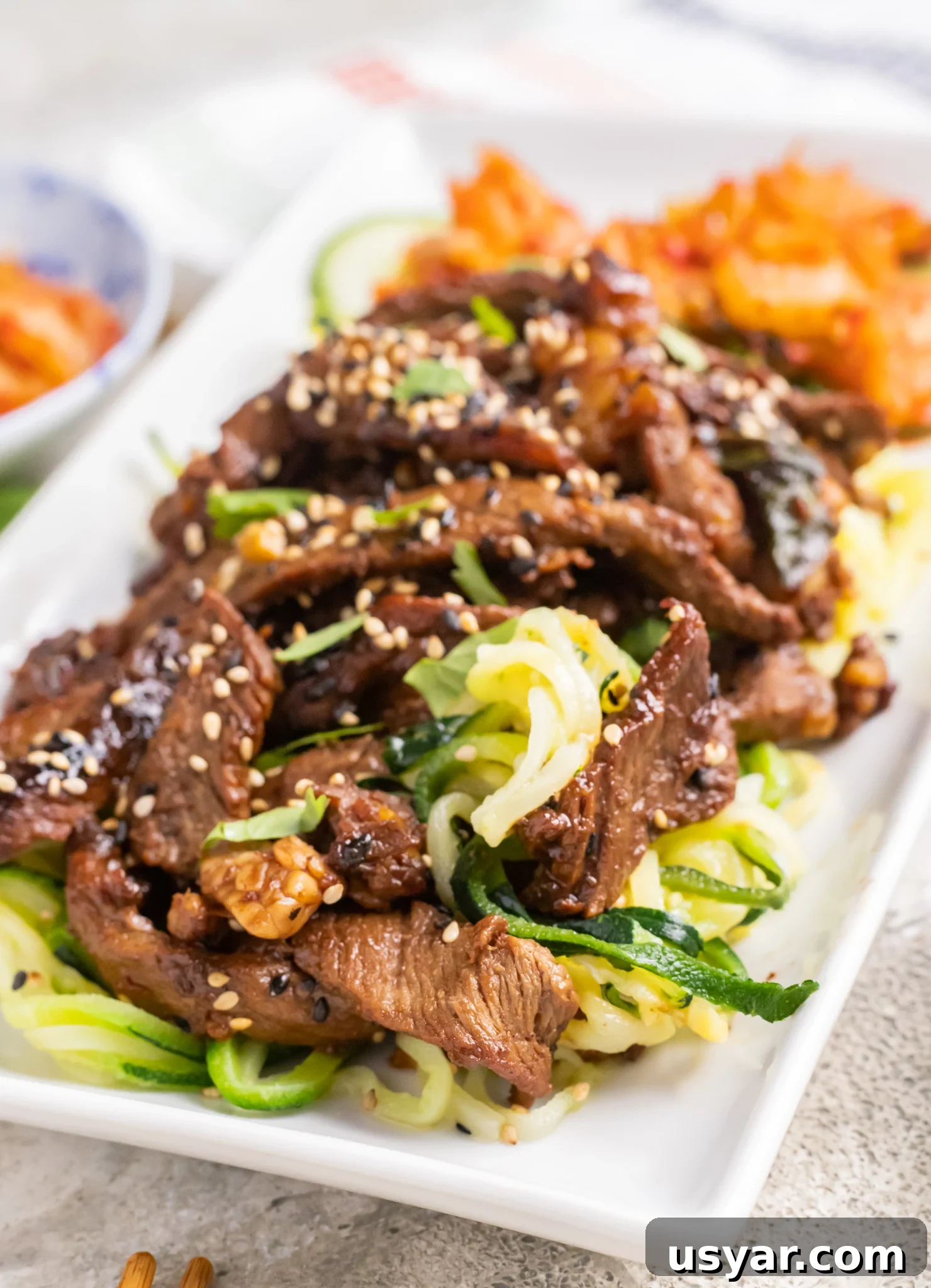 Korean Beef Bulgogi with Zucchini Noodles 2 Beef Bulgogi with Zucchini Noodles on a white plate.