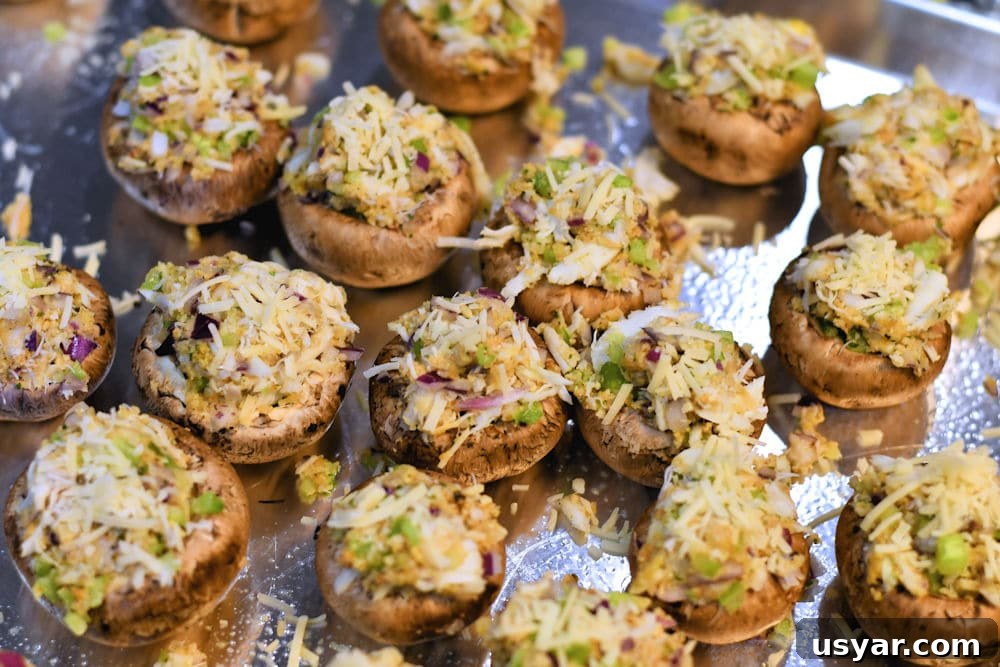 Crab Stuffed Mushrooms for Air Fryer or Oven 7 mushroom caps, filled with crab filling on a baking sheet