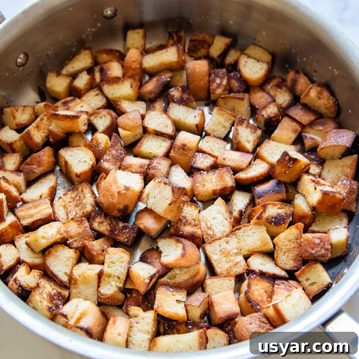 bread cubes toasted in a skillet.
