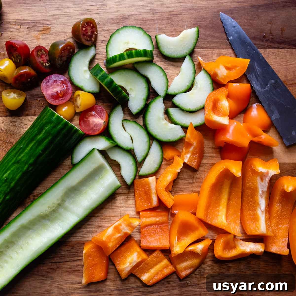 veggies chopped up on a wooden cutting board.