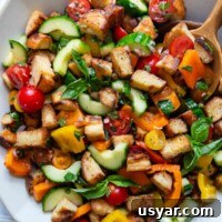 overhead shot of panzanella in a white serving bowl.