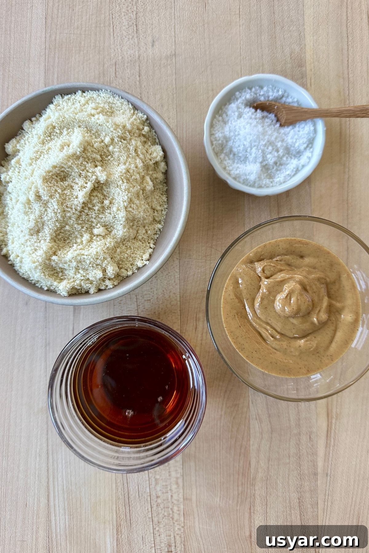 Homemade Copycat Nutter Butter Cookie Recipe 2 Ingredients for homemade Nutter Butter cookies including almond flour, maple syrup, peanut butter, and flaky sea salt