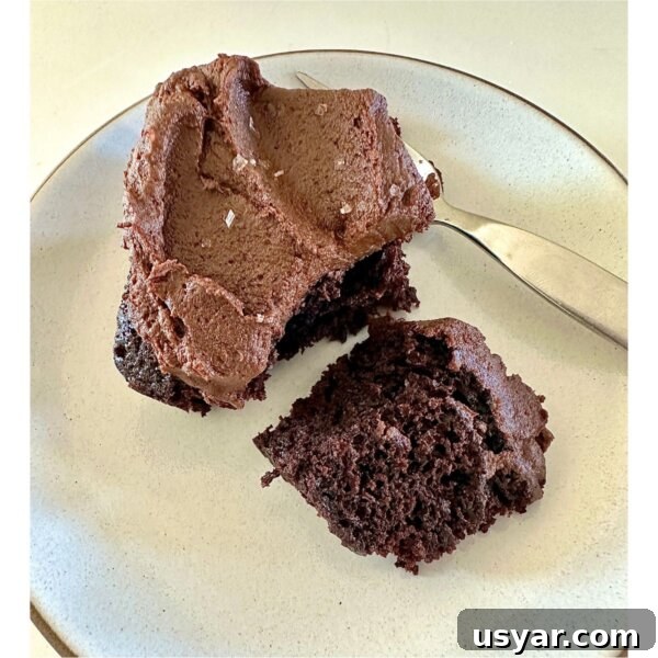 a slice of gluten-free vegan chocolate cake with sweet potato frosting on plate