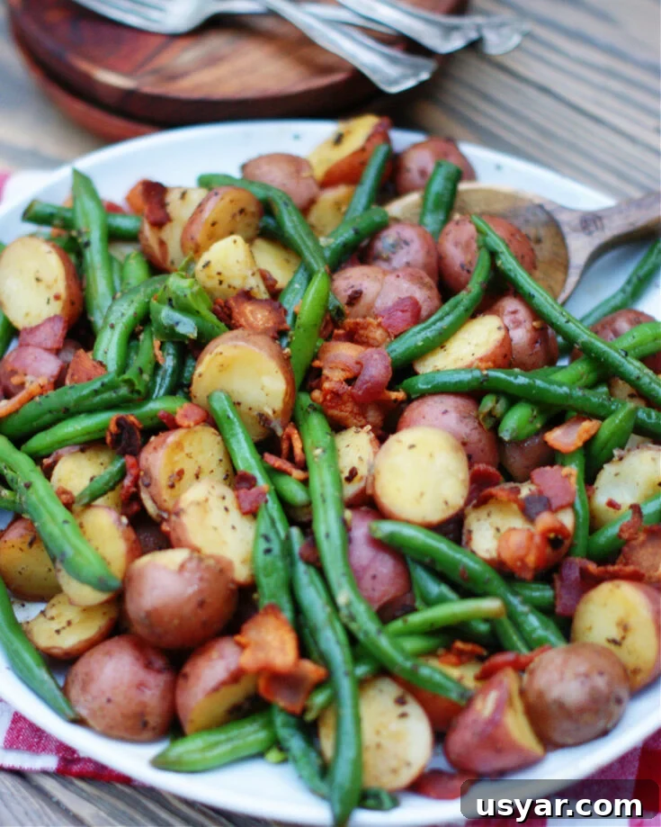 country style fresh green beans and new potatoes with crumbled bacon as a vegetable side dish