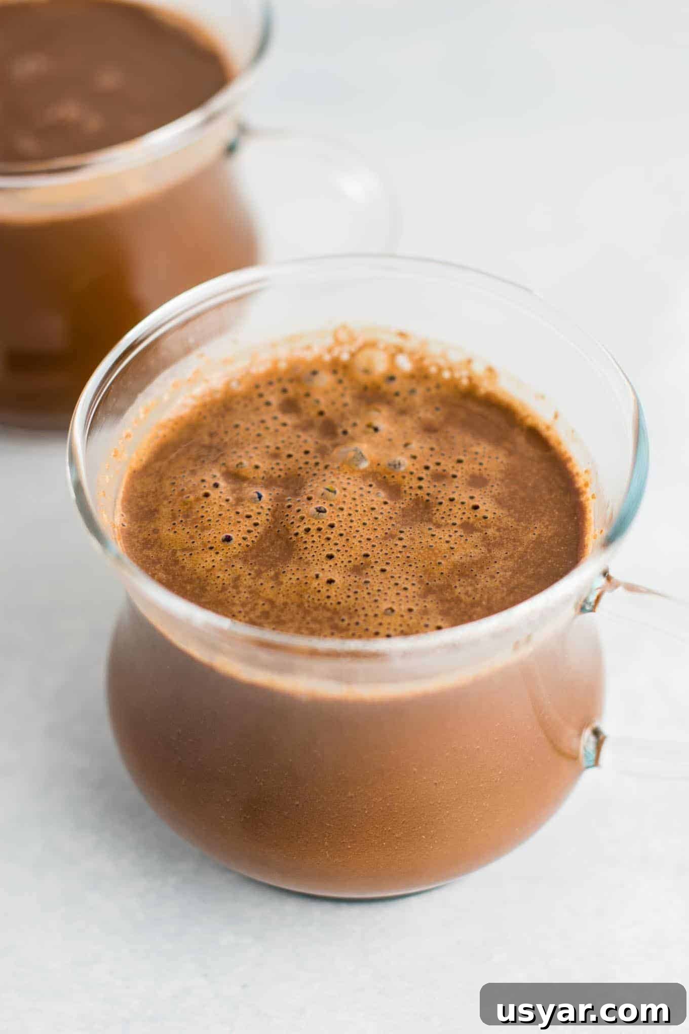 Decadent Vegan Hot Chocolate Recipe 2 Easy 4 Ingredient vegan hot chocolate recipe made with almond milk. Dairy free, gluten free, and vegan. The perfect cozy winter drink! #vegan #hotchocolate #drinks #christmas #dairyfree