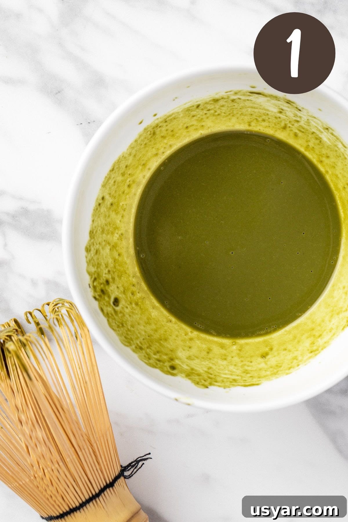 Oat Milk Matcha Latte Recipe 4 A process photo illustrating step 1: whisking the matcha powder and water together.