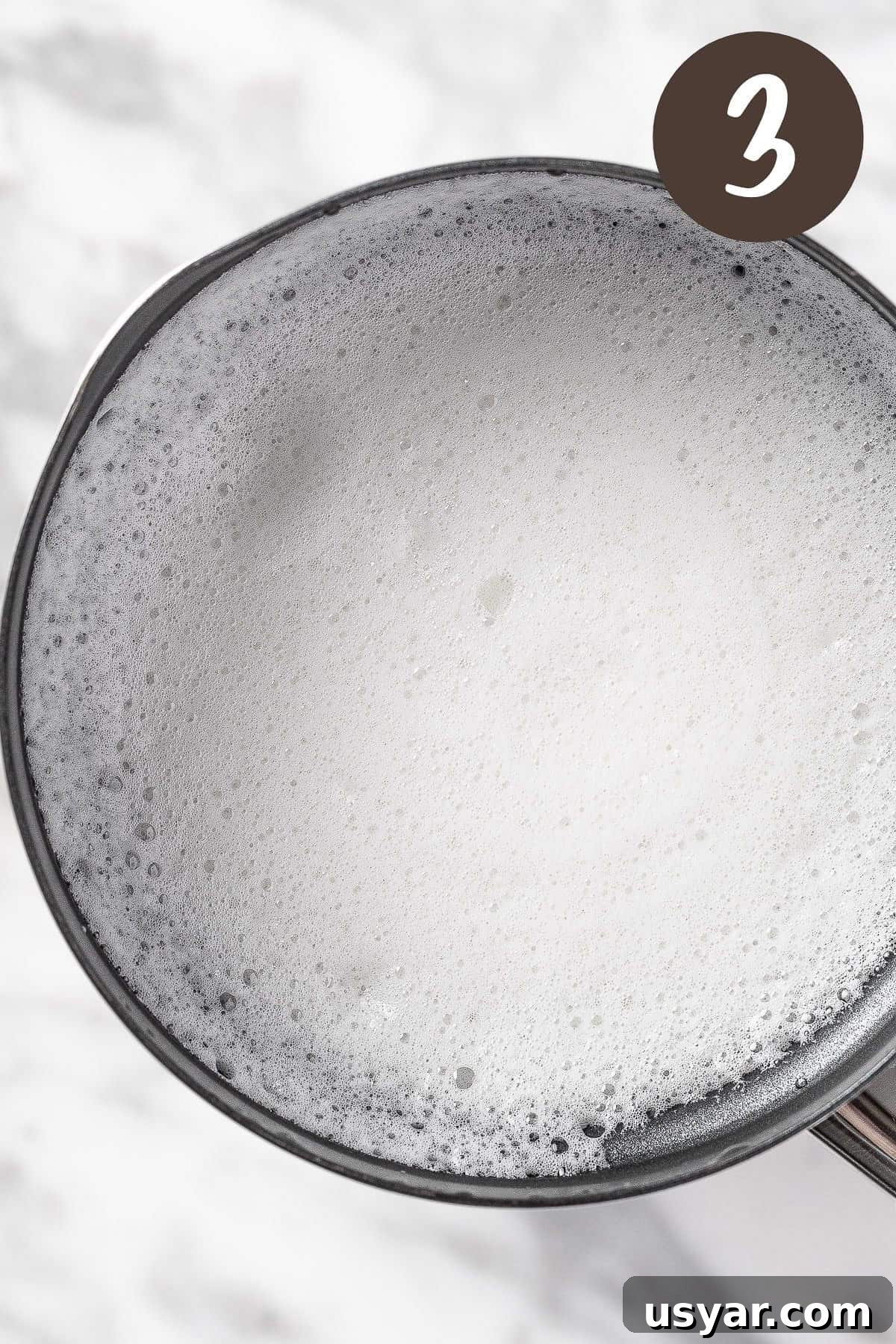 Oat Milk Matcha Latte Recipe 6 A process photo illustrating step 3: froth the oat milk.