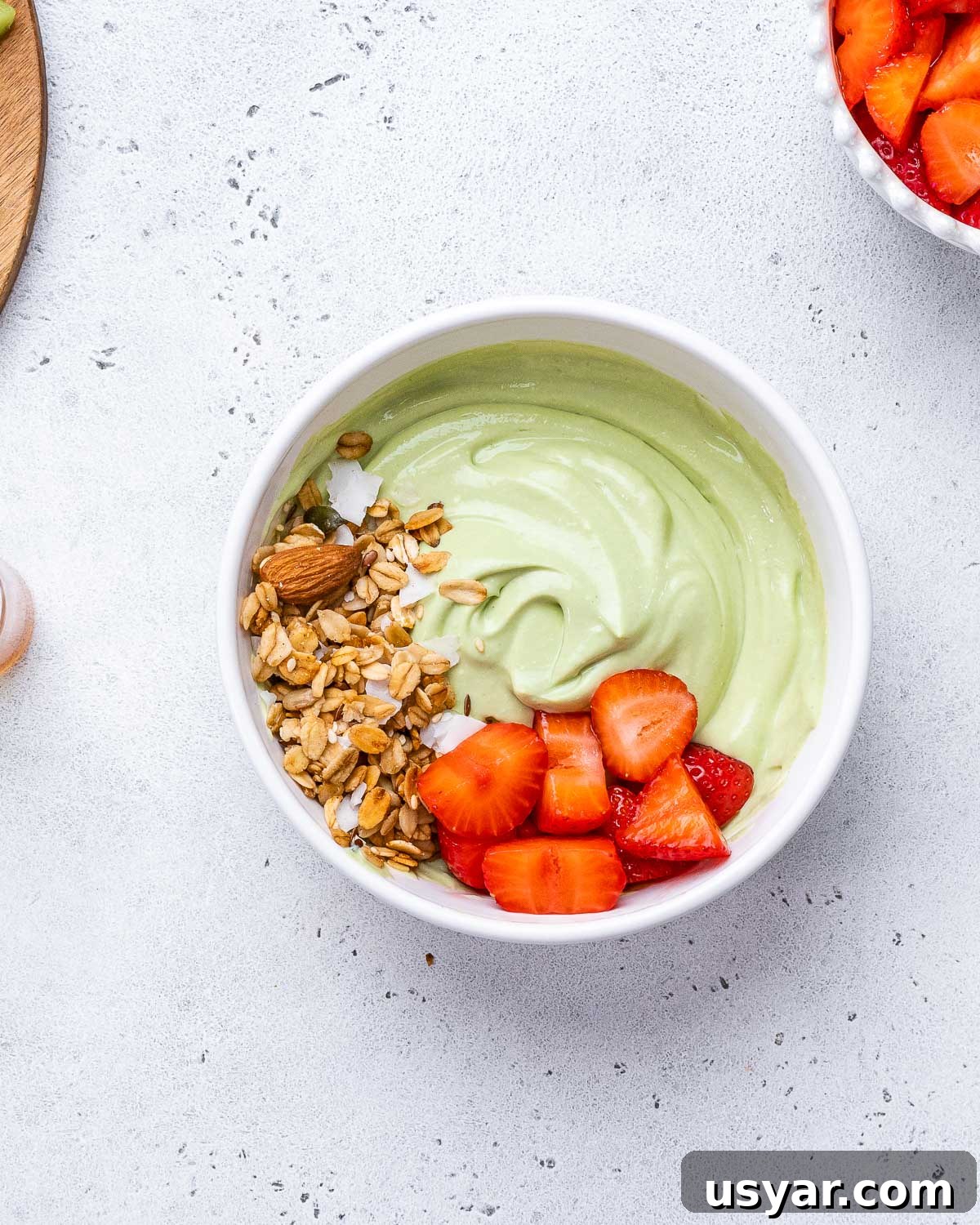 Matcha Yogurt topped with granola and fruit.