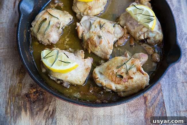 Oven Baked Chicken Thighs topped with Lemon and Rosemary in an Oven Safe Skillet Oven Baked Chicken Thighs topped with Lemon and Rosemary in an Oven Safe Skillet