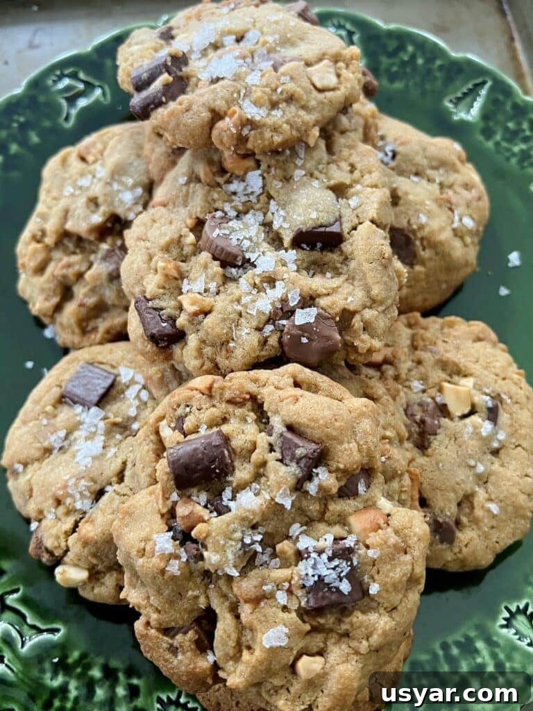 Sea Salt Peanut Butter Cup Chocolate Chip Cookies with Nuts 2 Close up of Peanut Butter Cup Chocolate Chip Cookies with large pieces of flaky sea salt.