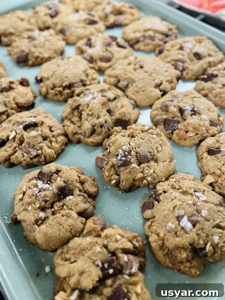 Sea Salt Peanut Butter Cup Chocolate Chip Cookies with Nuts 7 Just baked Salted Peanut Butter Cup Chocolate Chip Cookies on sheet pan.