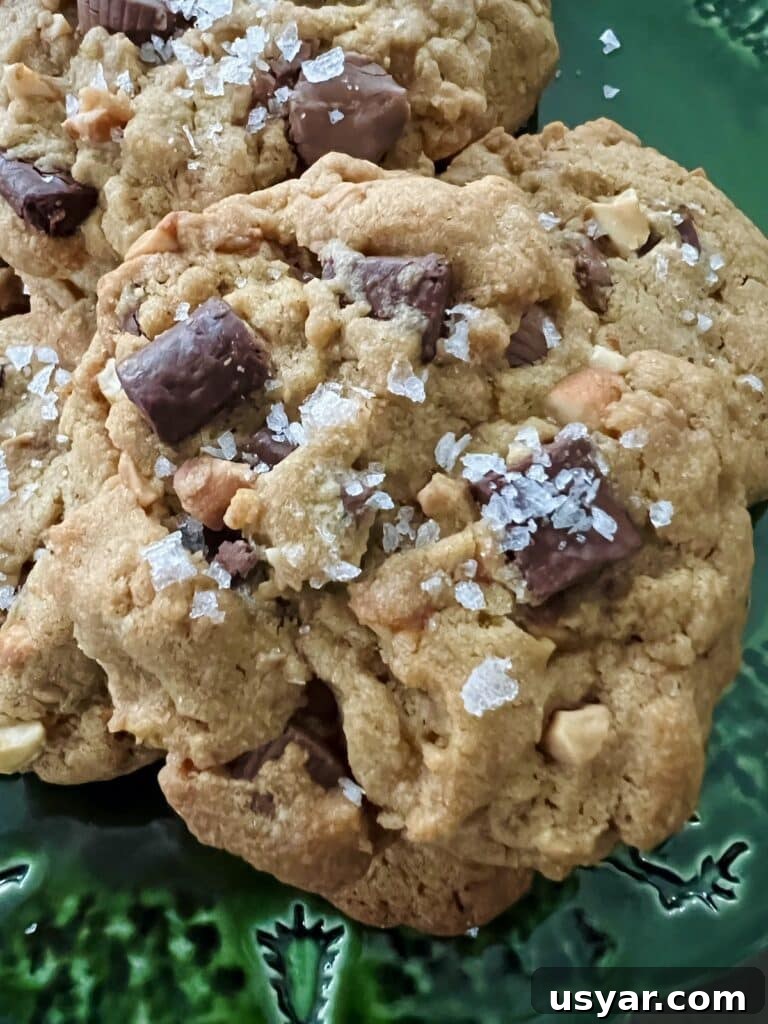 Sea Salt Peanut Butter Cup Chocolate Chip Cookies with Nuts 9 Close up of Peanut Butter Cup Chocolate Chip Cookies with large pieces of flaky sea salt.