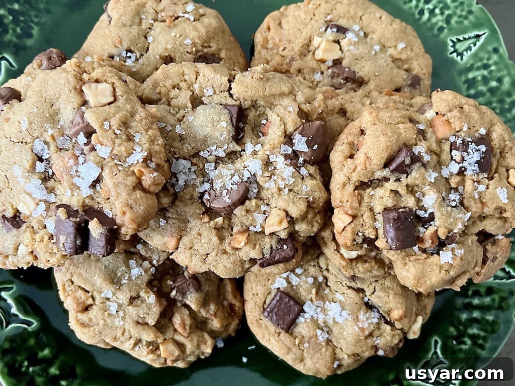 Close up of Peanut Butter Cup Chocolate Chip Cookies with large pieces of flaky sea salt.