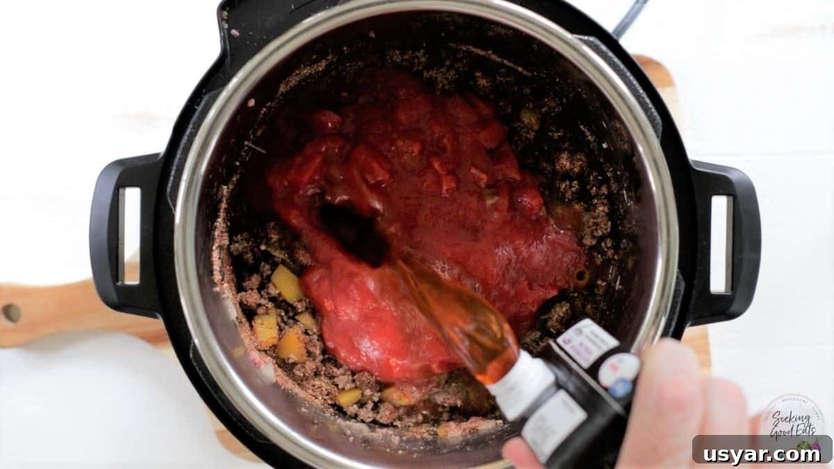 Beef Taco Soup with Ground Beef and Beans 4 Adding beef broth to the instant pot.