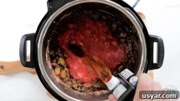 Beef Taco Soup with Ground Beef and Beans 8 Adding beef broth to the instant pot.