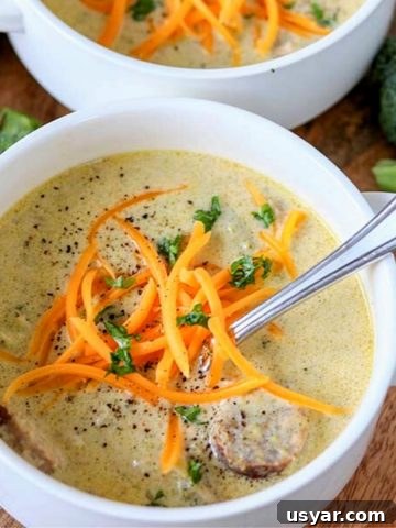 A bowl of cheesy keto broccoli soup with beer and bratwurst