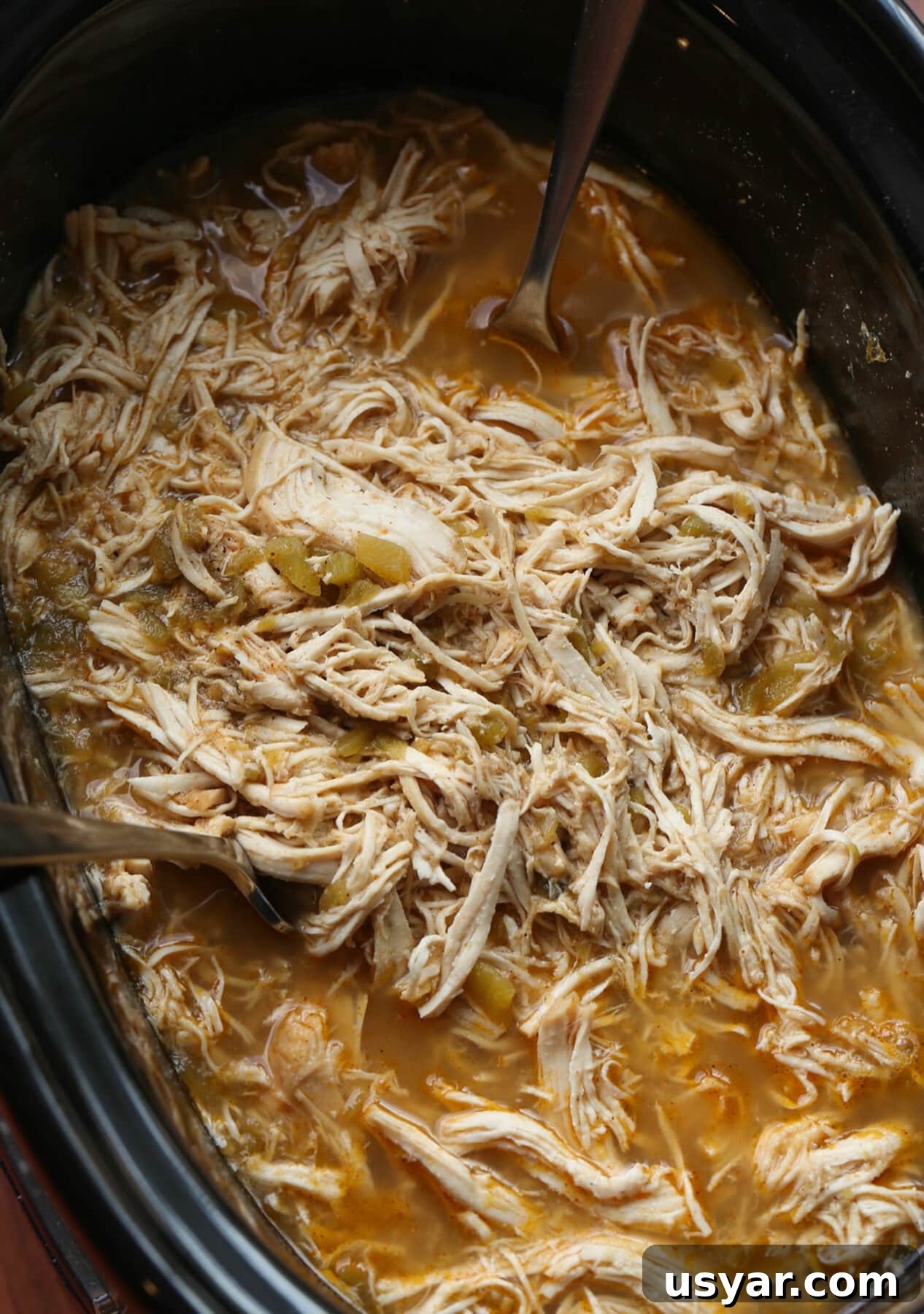 This Beergarita pulled chicken is a citrus, Tex-Mex, flavor-packed pulled chicken recipe! Sweet and smoky, this easy Crock Pot chicken recipe is great on tacos, over rice, in quesadillas and beyond! Pulled chicken in a crock pot
